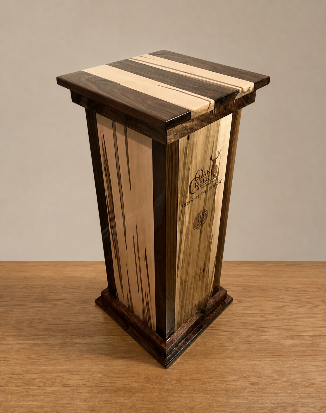 Flush hardwood mounting top on a square walnut and ambrosia maple taxidermy pedestal
